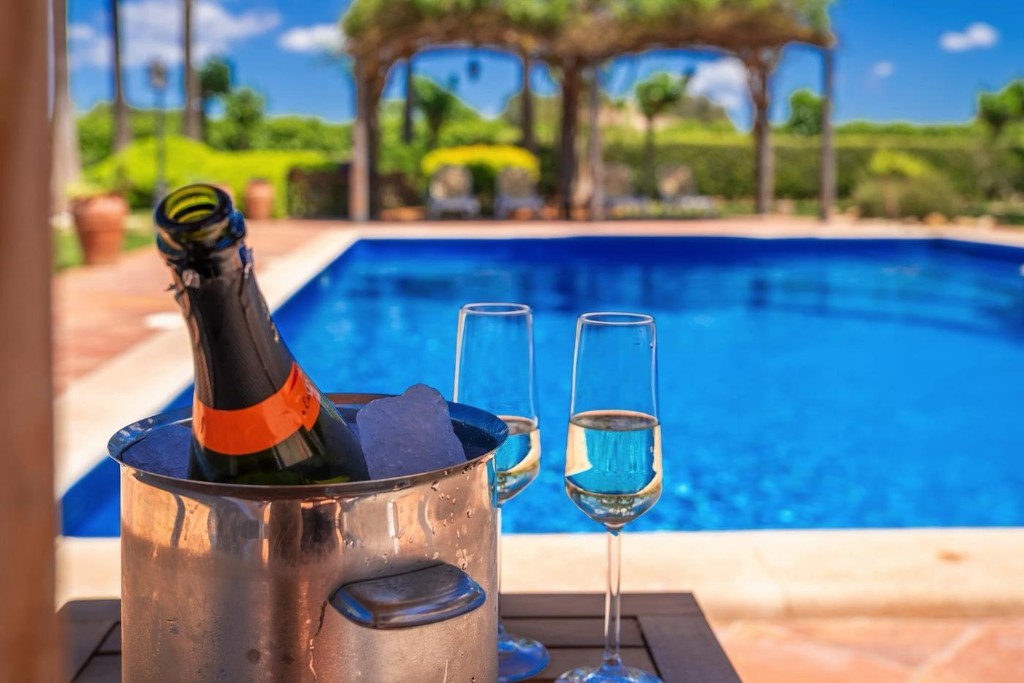 Champagne cooler and glasses by the pool