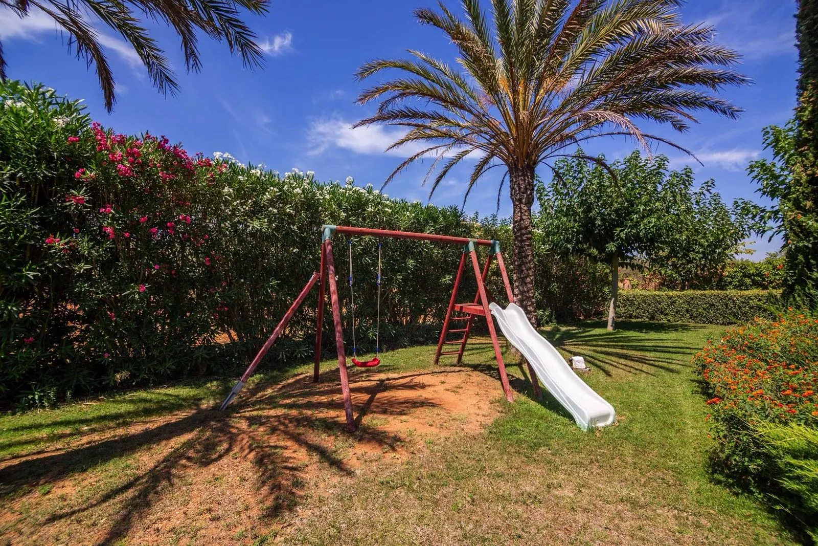 Play area with a swing and slide